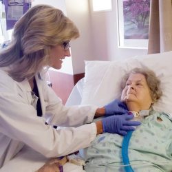 Current Research Related to Mechanical Ventilation and Speaking Valve Use Doctor adjusting patient's trach