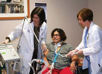 Understanding the Management of Patients Undergoing Prolonged Weaning from Mechanical Ventilation Two caregivers with ventilator patient