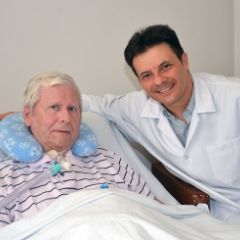 Current Research Related to Mechanical Ventilation and Speaking Valve Use Doctor adjusting patient's trach